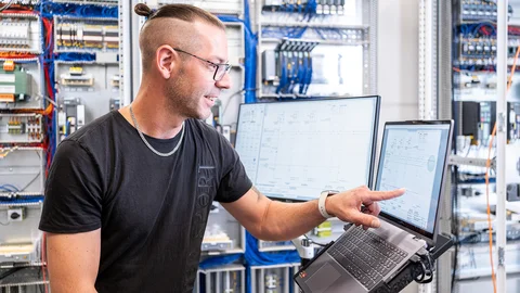 Person points to laptop with PDF circuit diagram